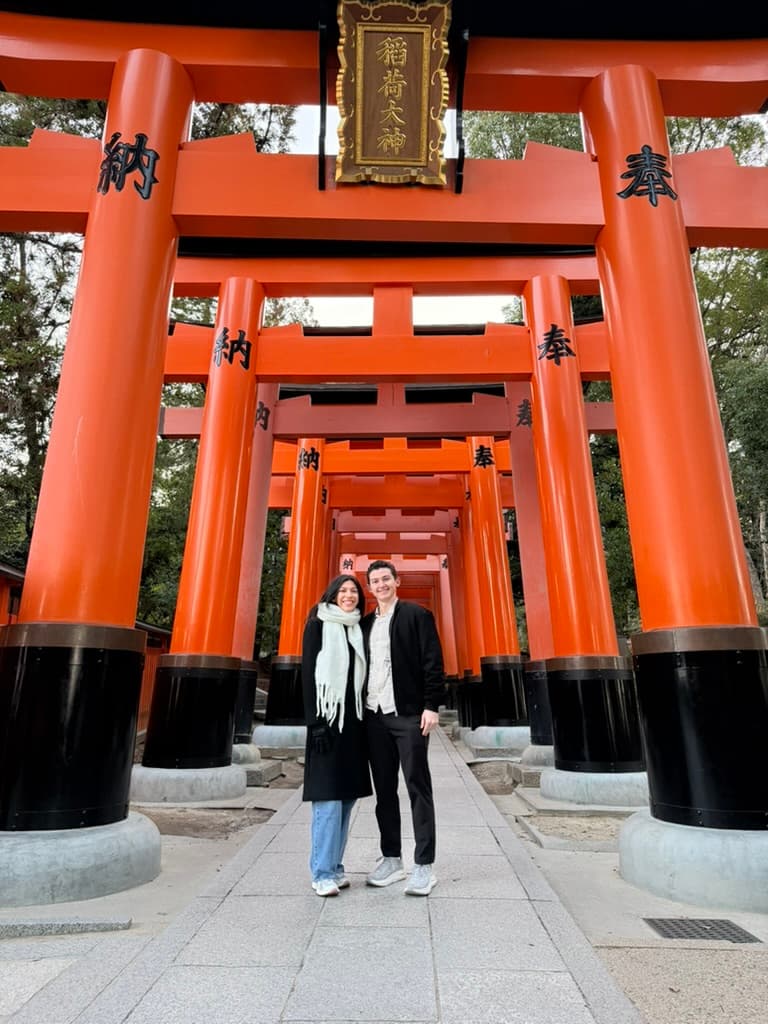 Sofia and Riley beneath red torii gates in Japan